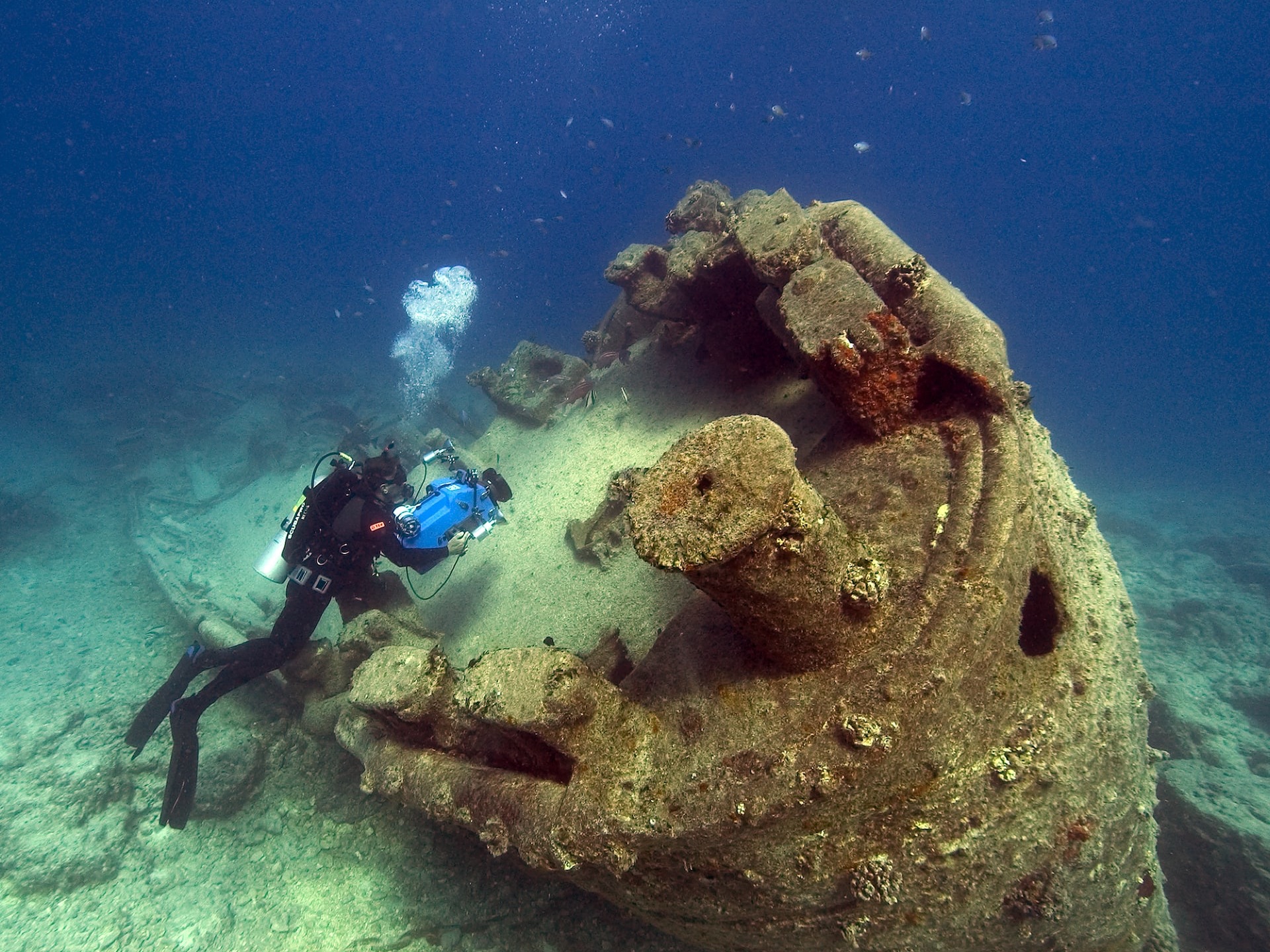 person scuba driving underwater